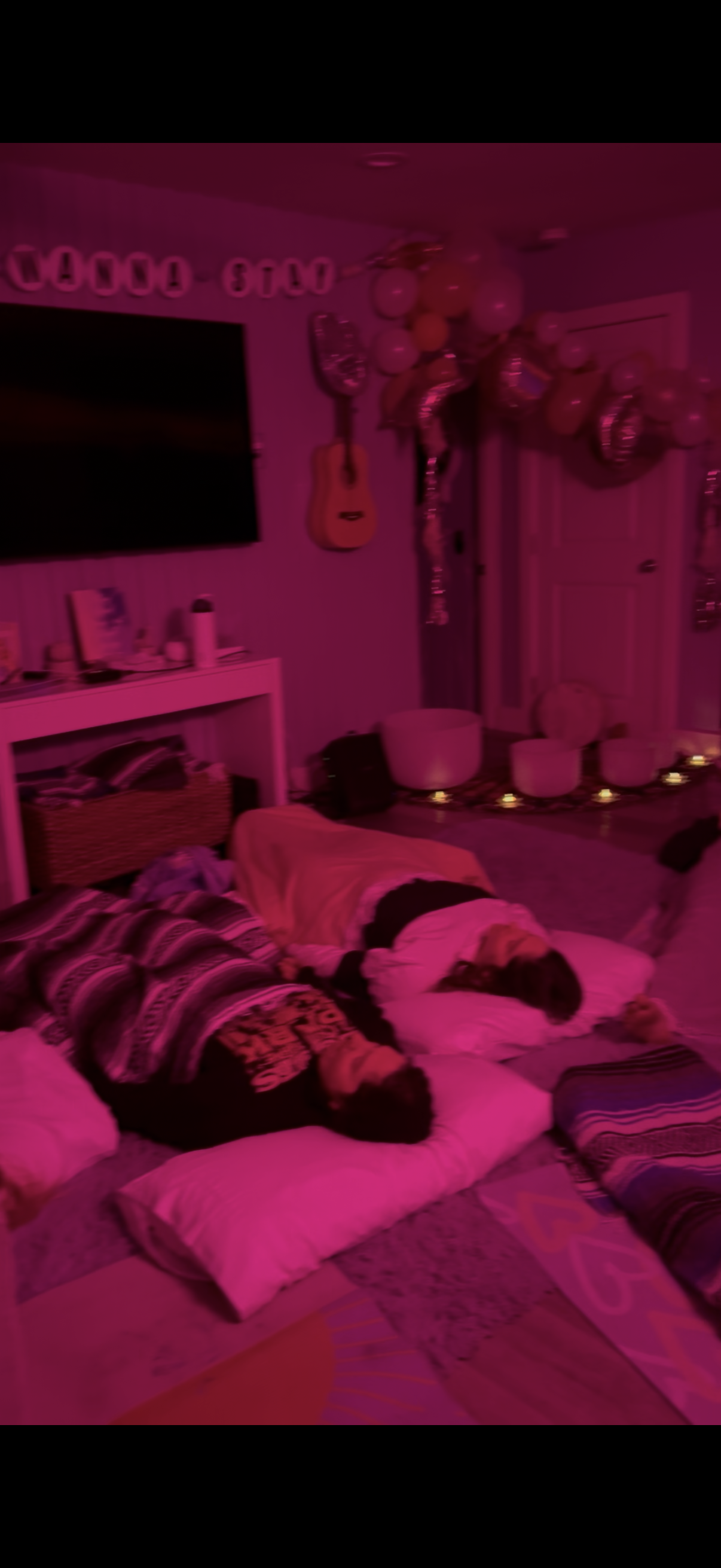 Pink ambient lighting during evening bachelorette breathwork session