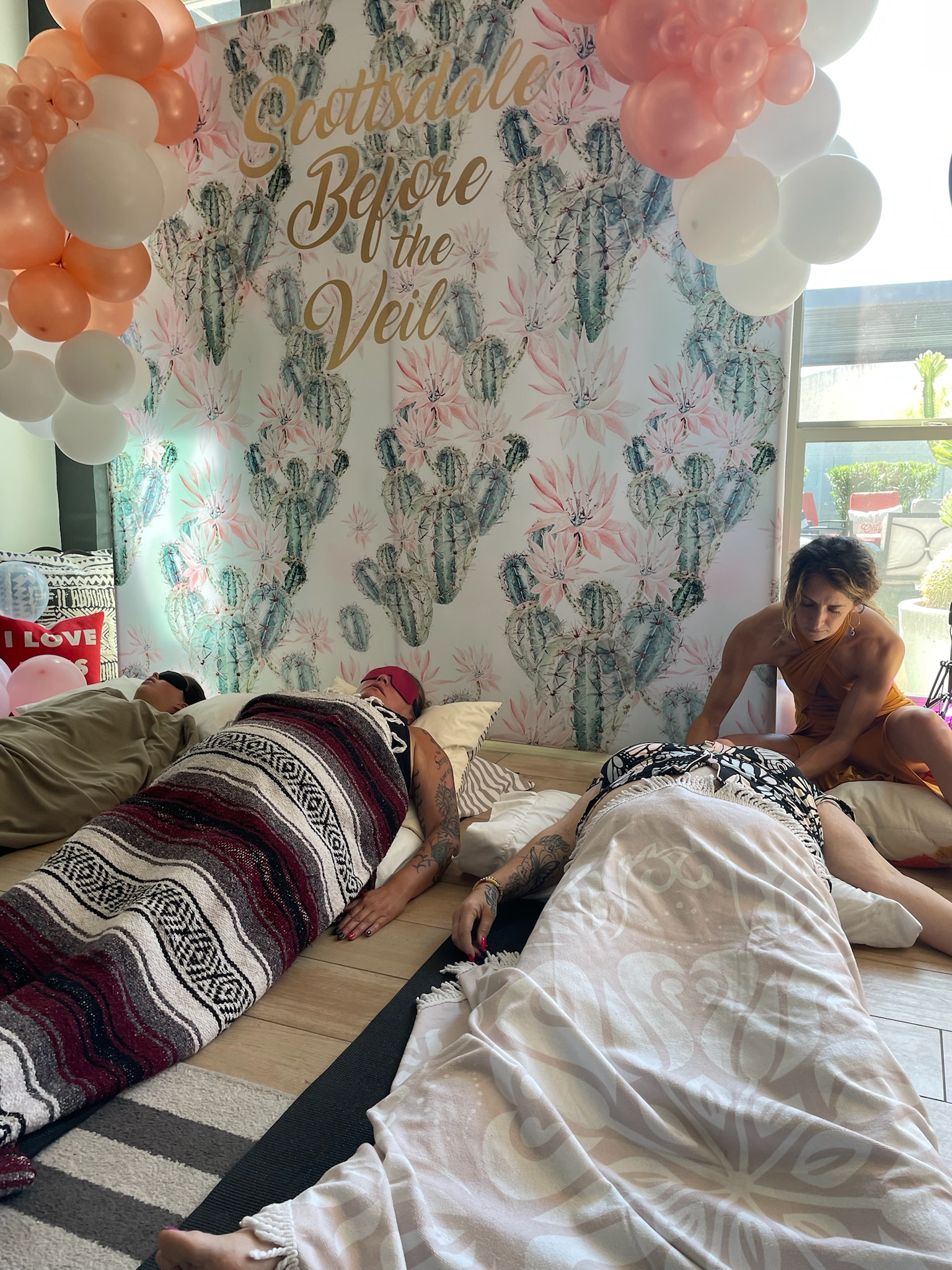 Close up of bachelorette party breathwork session with Scottsdale Before the Veil backdrop