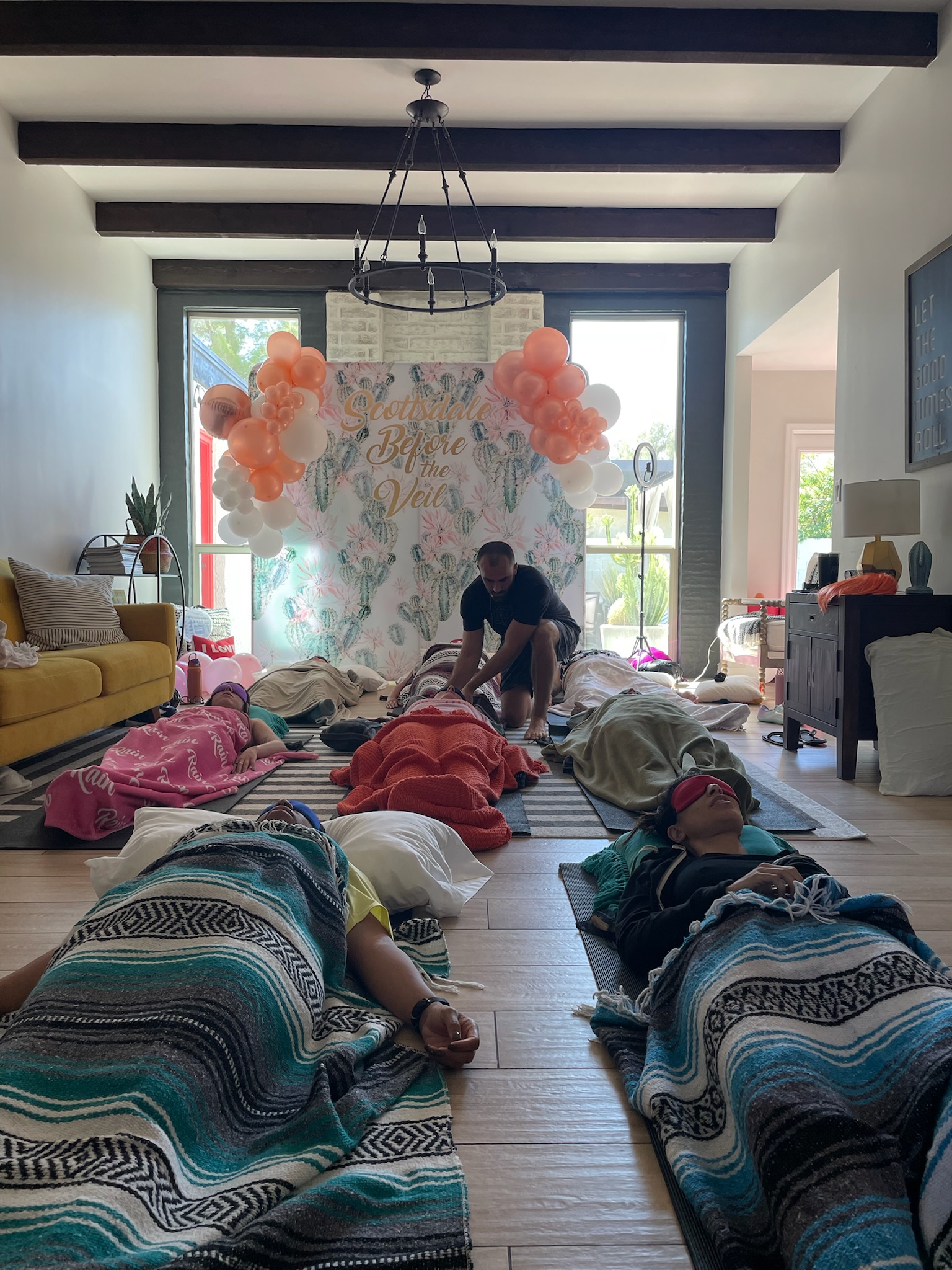 Bachelorette party group breathwork session with Scottsdale Before the Veil backdrop