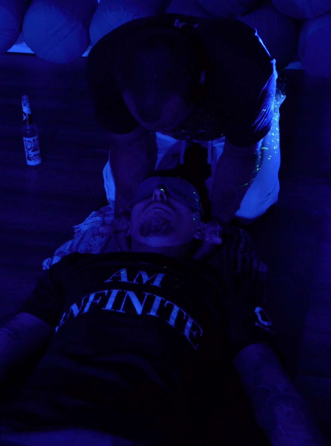 Live facilitator giving hands-on, present support to a participant during a Breathwork session, the kind of real-time responsiveness pre-recorded 9D tracks cannot offer
