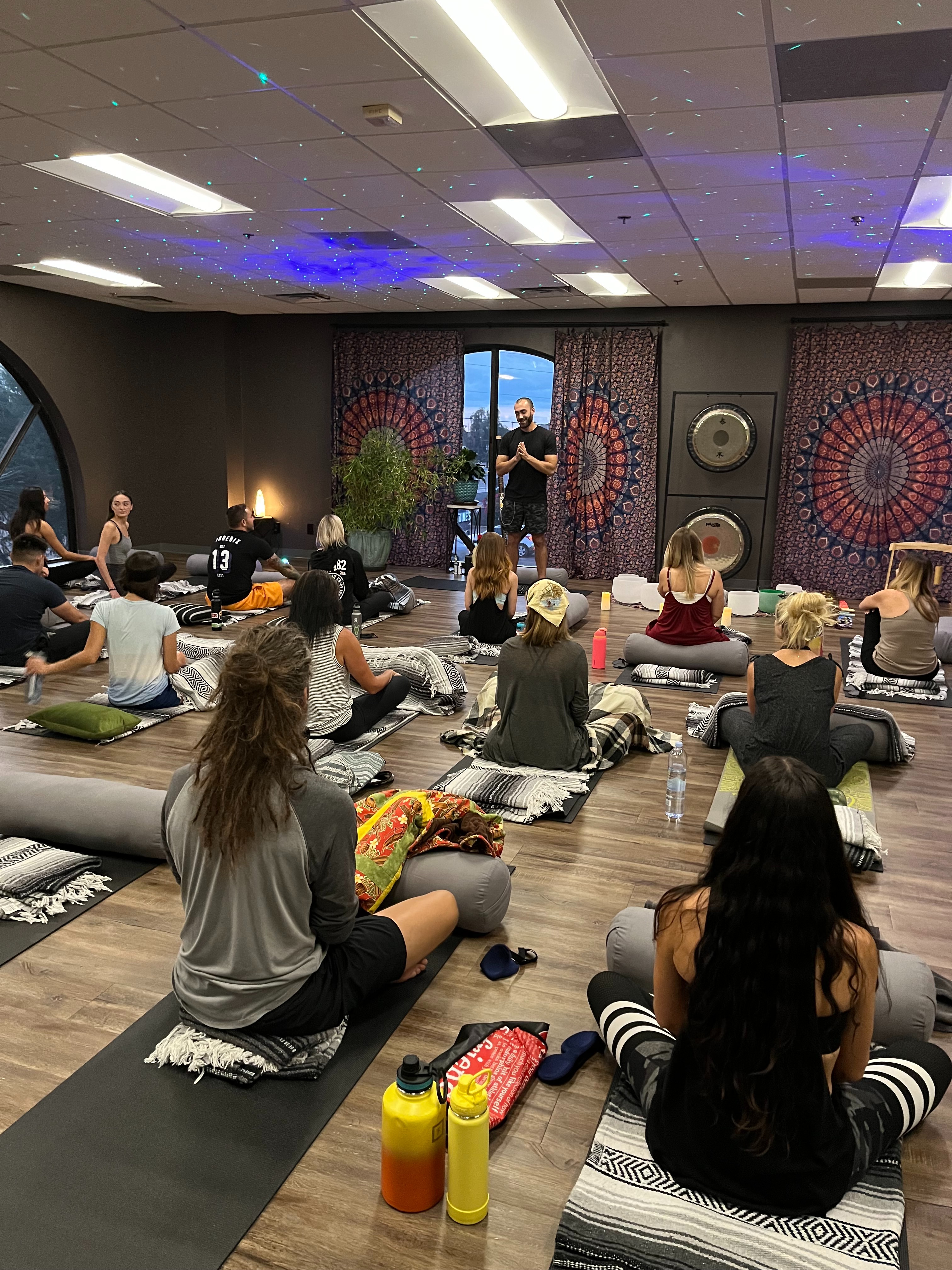 Ryan McBurney guiding a group Breathwork class with participants seated on mats