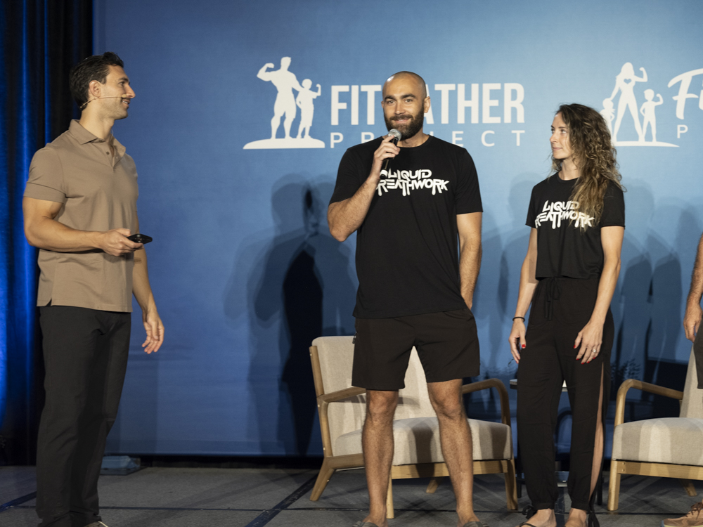 Ryan McBurney speaking on stage at Fit Father Project conference