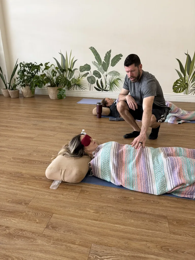 Nigel James giving hands-on somatic support during a Breathwork class
