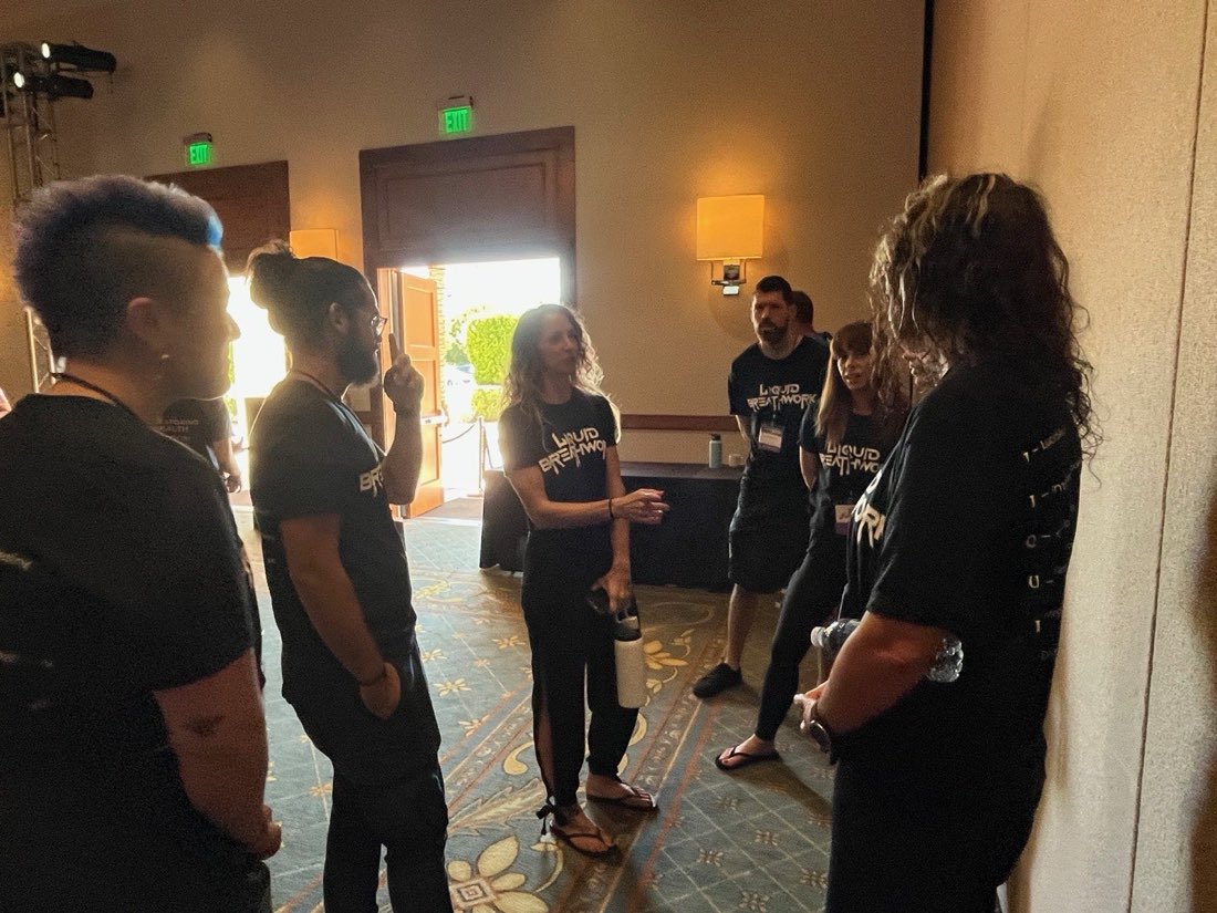 Liquid Breathwork facilitator trainees connecting between sessions at a training event