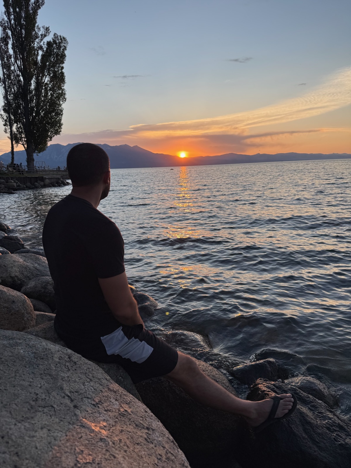 Sunset over Lake Tahoe from the rocky shoreline near the South Lake Tahoe Breathwork certification intensive