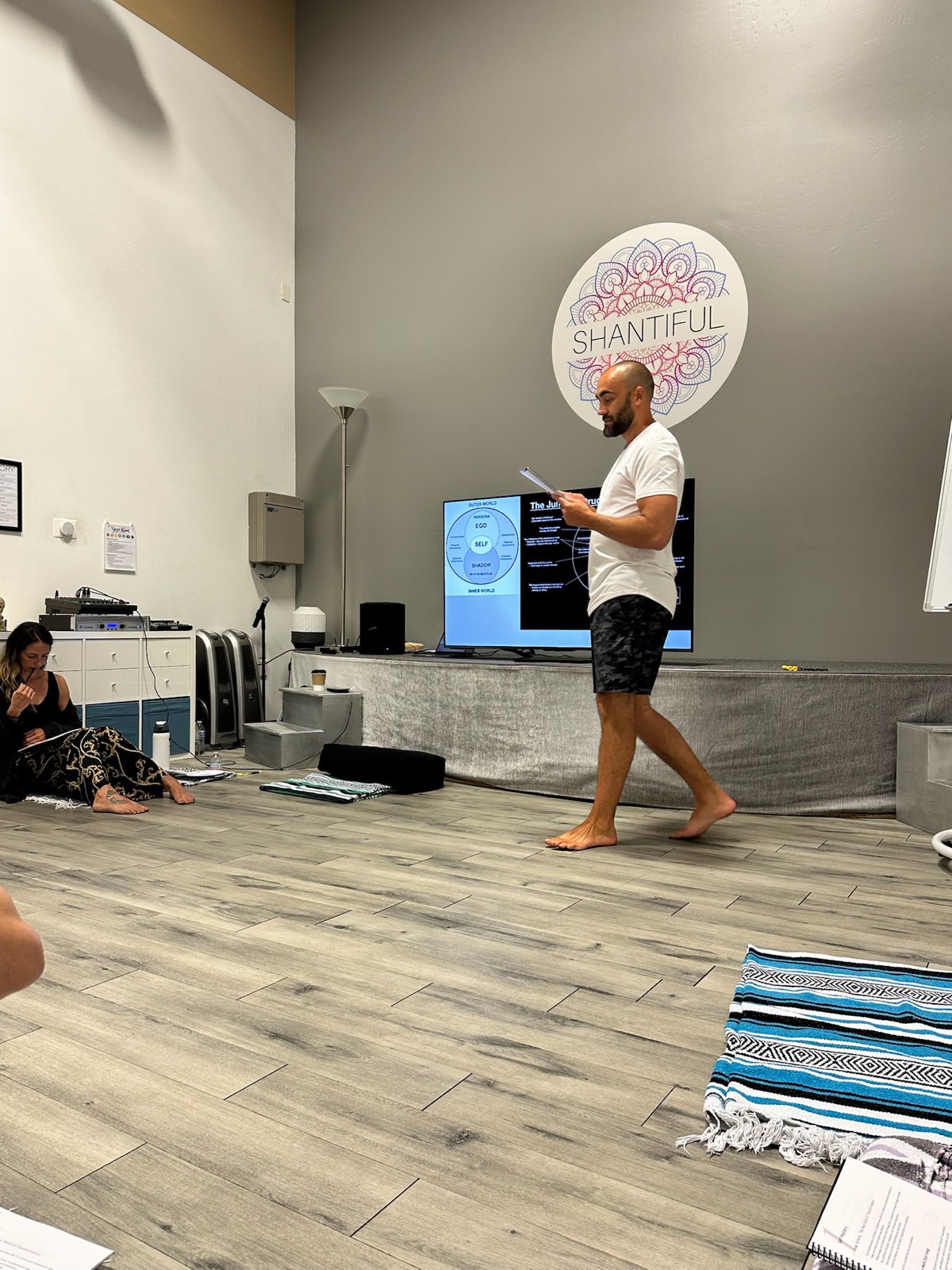 Ryan McBurney leading a Liquid Breathwork facilitator training session with students in a studio