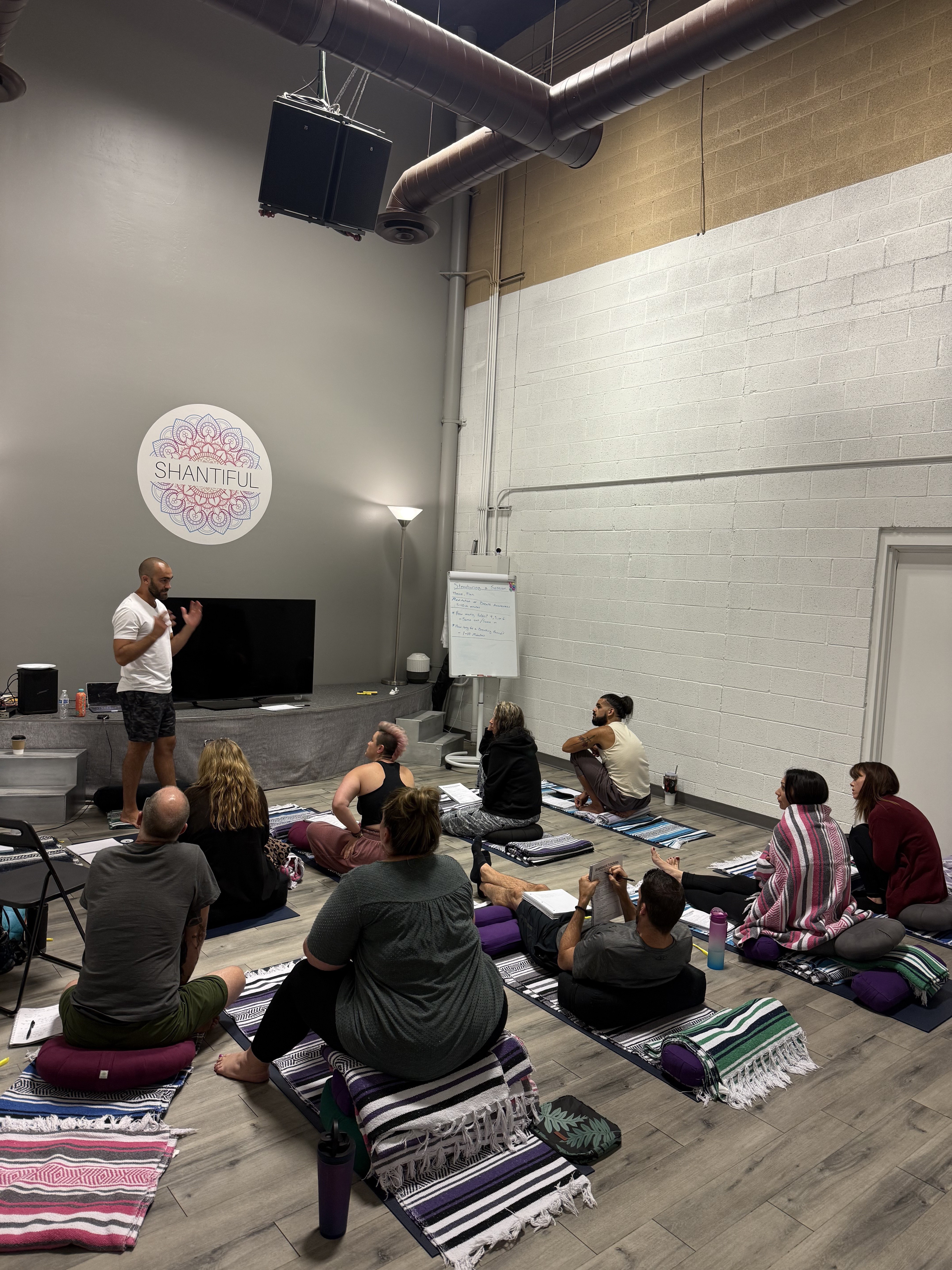 Ryan McBurney teaching breathwork facilitator certification workshop to students at Shantiful studio