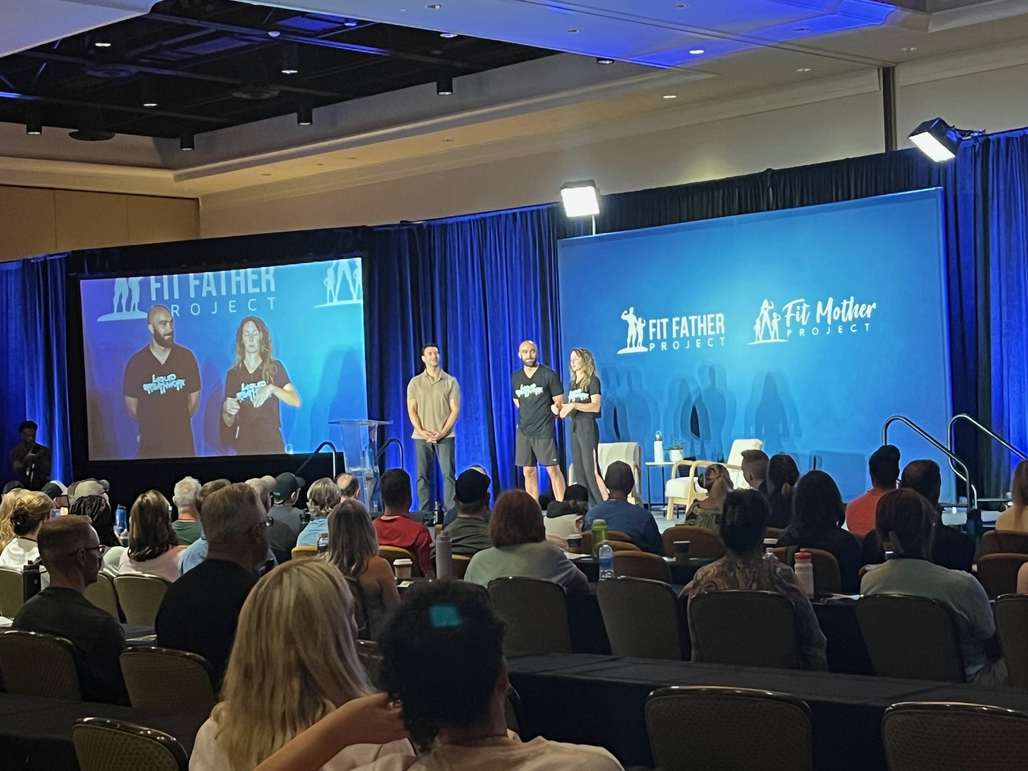 Liquid Breathwork founders Ryan McBurney and Shelby Von Oepen presenting breathwork facilitation on stage at the Fit Father Project health conference